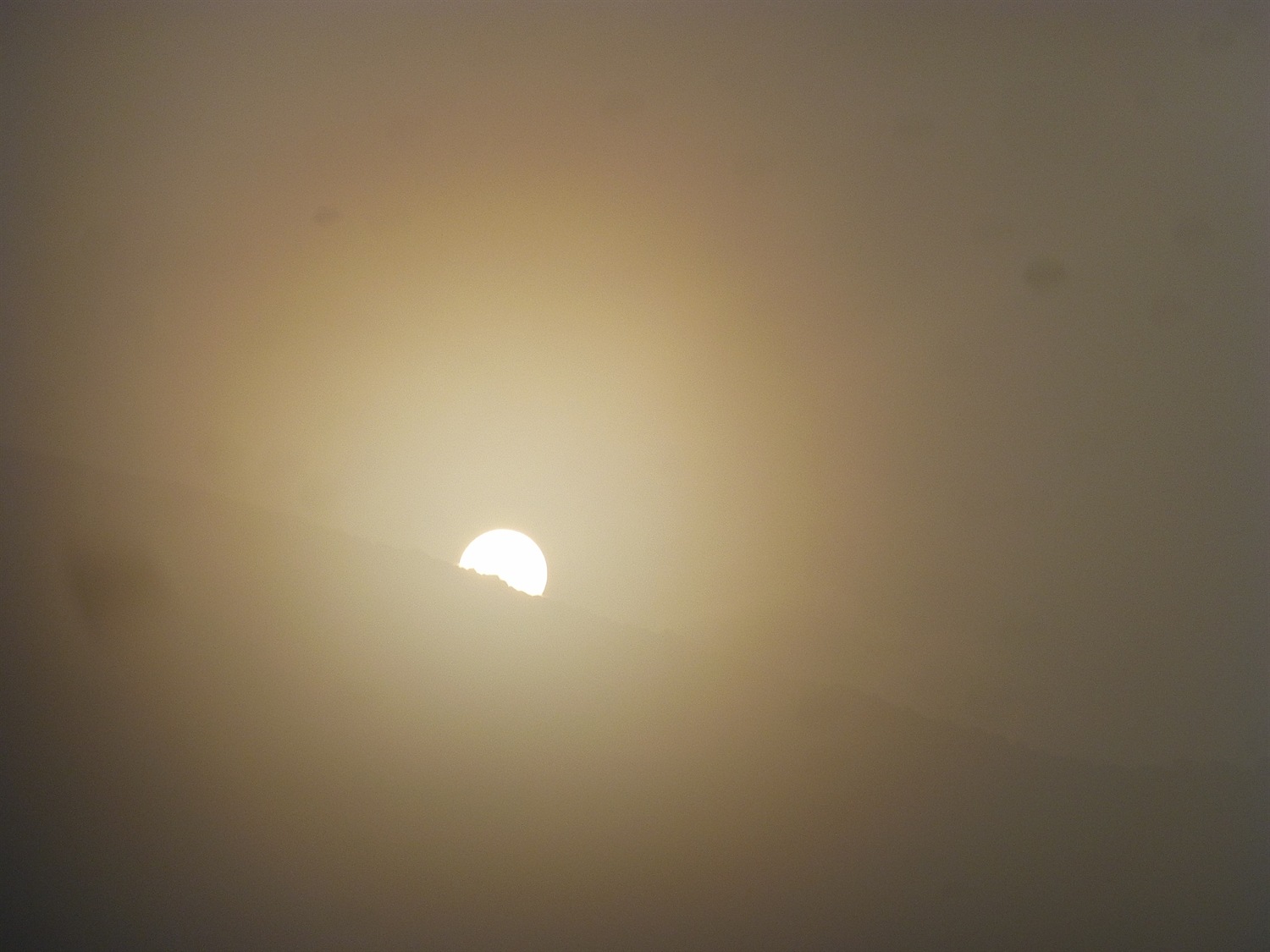 The sun tried to get his hat on but was beaten by the mist