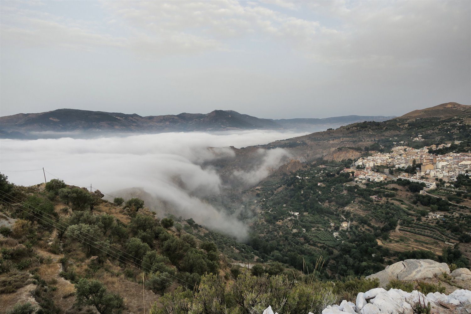 The sea of cloud cascading over the crags just like a wave.