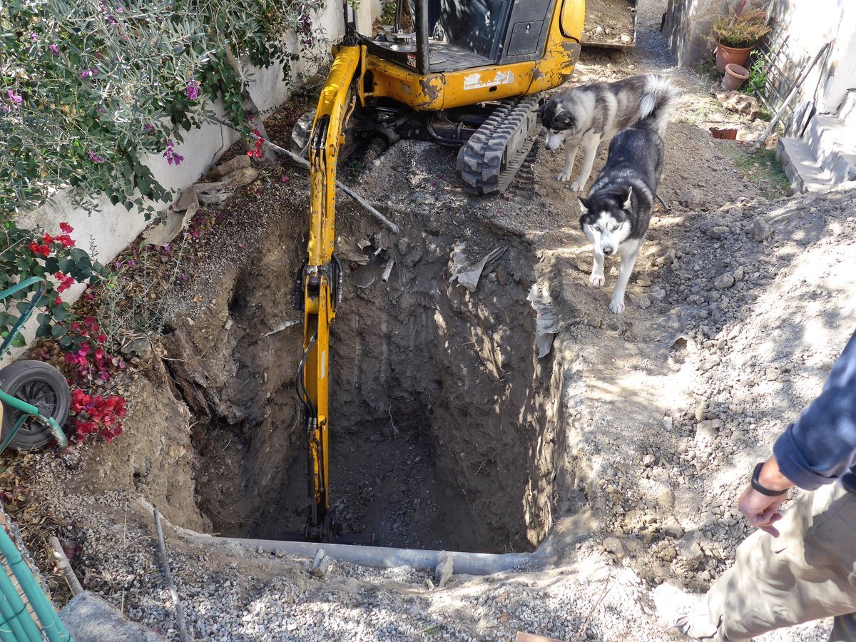 Inspecting the hole that the digger had dug